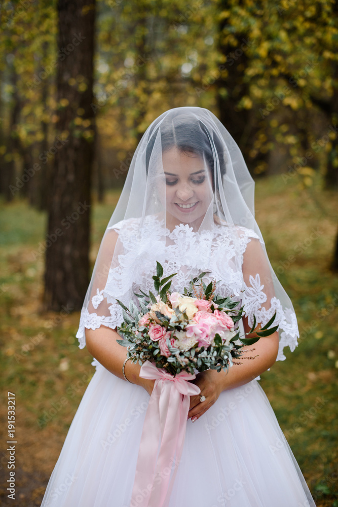 happy bride on autumn forest. young beauty bride with big eye