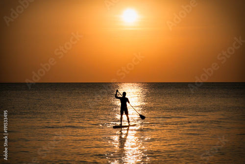 Silhouette of man standing up at paddle Board on sunset, Boracay. Philippines. © Aleksandar Todorovic