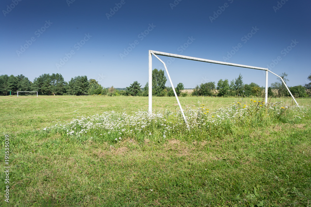 Soccer field with blue sky in the countryside.