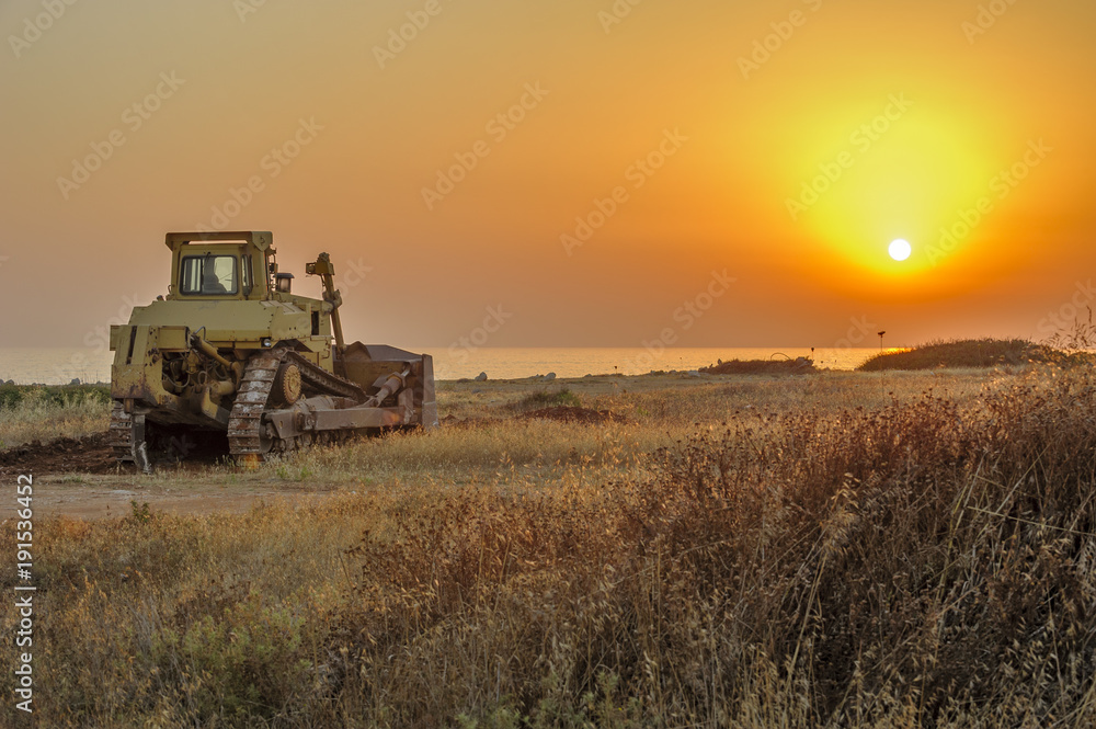 Naklejka premium Bulldozer on the beach