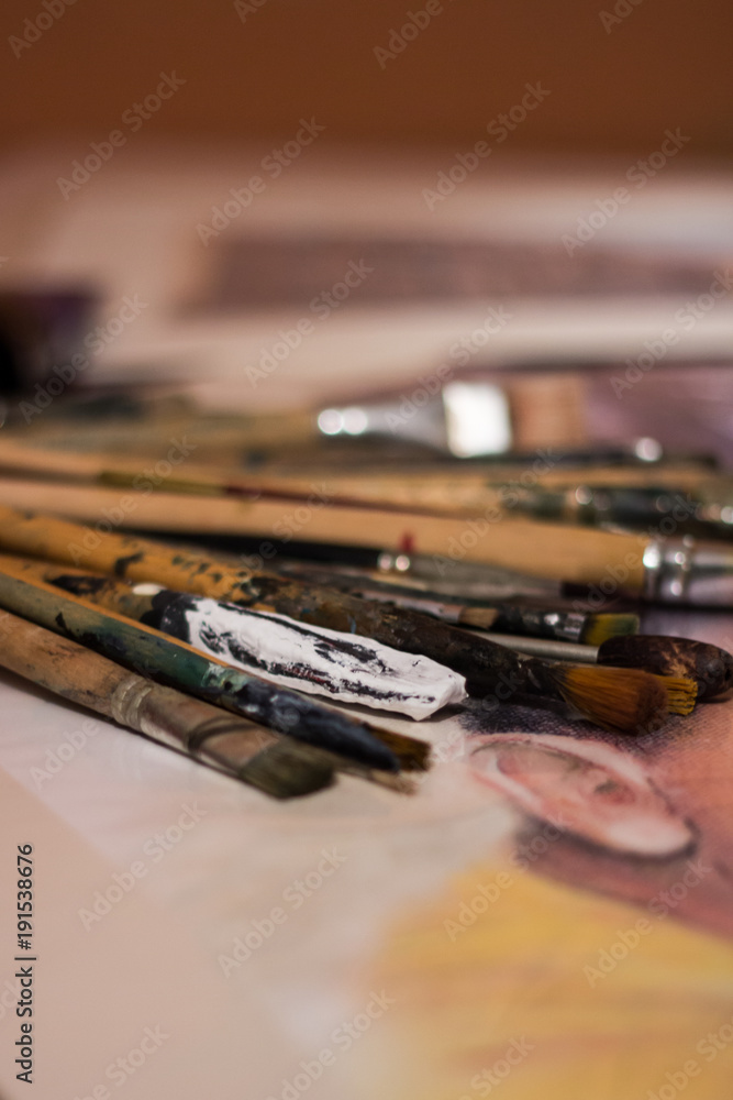 Brushes stained with paints lying on the table Brushes stained with paints lying on the table