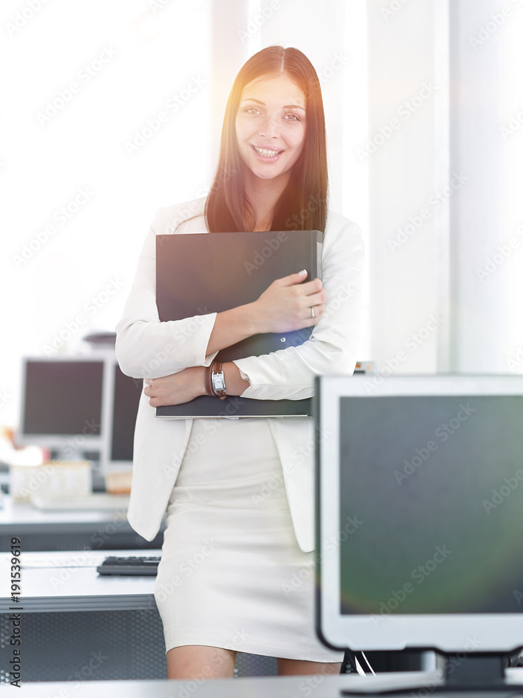 female assistant with documents standing in the office.photo with copy space. female assistant with documents standing in the office.photo with copy space.
