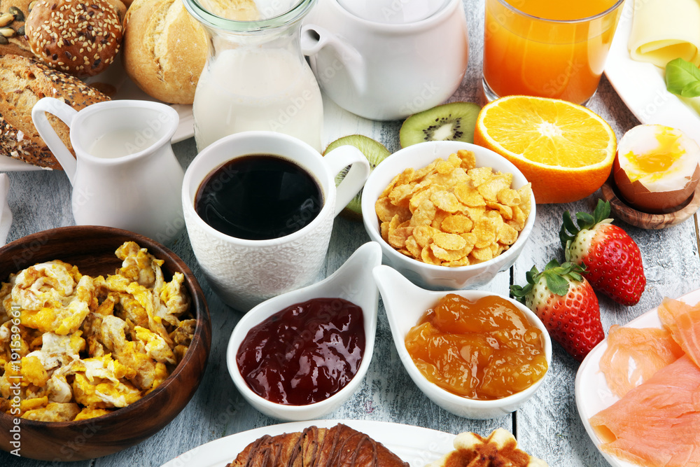 breakfast on table with waffles, croissants, coffe and juice breakfast on table with waffles, croissants, coffe and juice