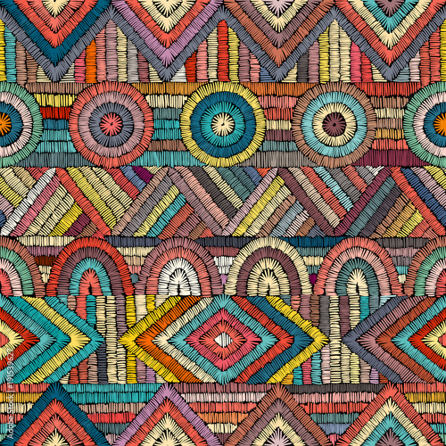 Embroidery - seamless ornament. Colored lines on a black background. Handmade. Ethnic and tribal motifs. Print in the bohemian style.