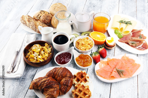 Obraz na plátně breakfast on table with waffles, croissants, coffe and juice