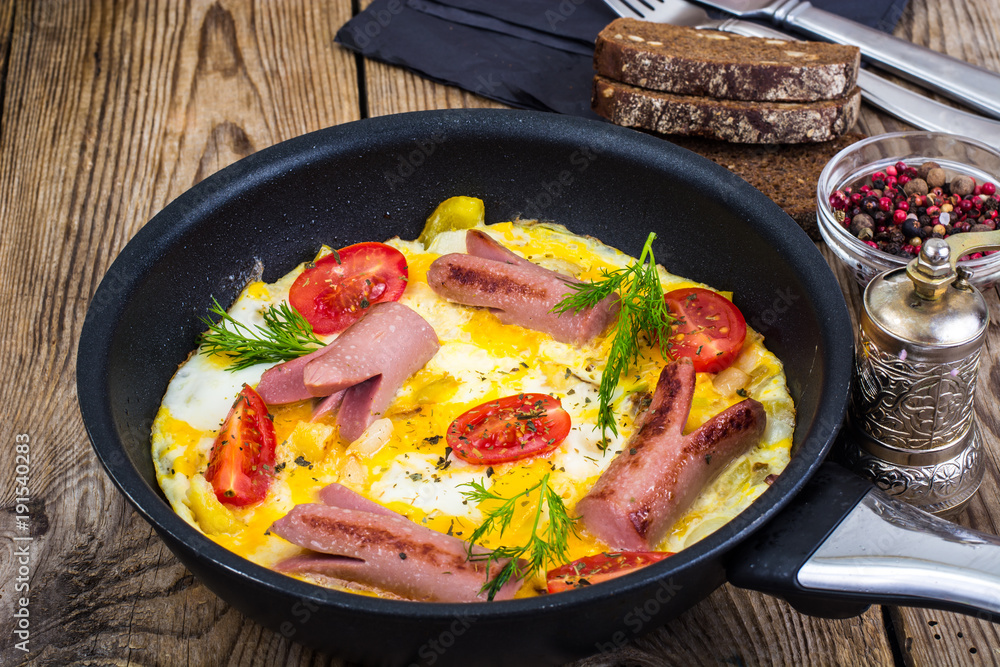 Breakfast for the family. Omelette with sausages Breakfast for the family. Omelette with sausages