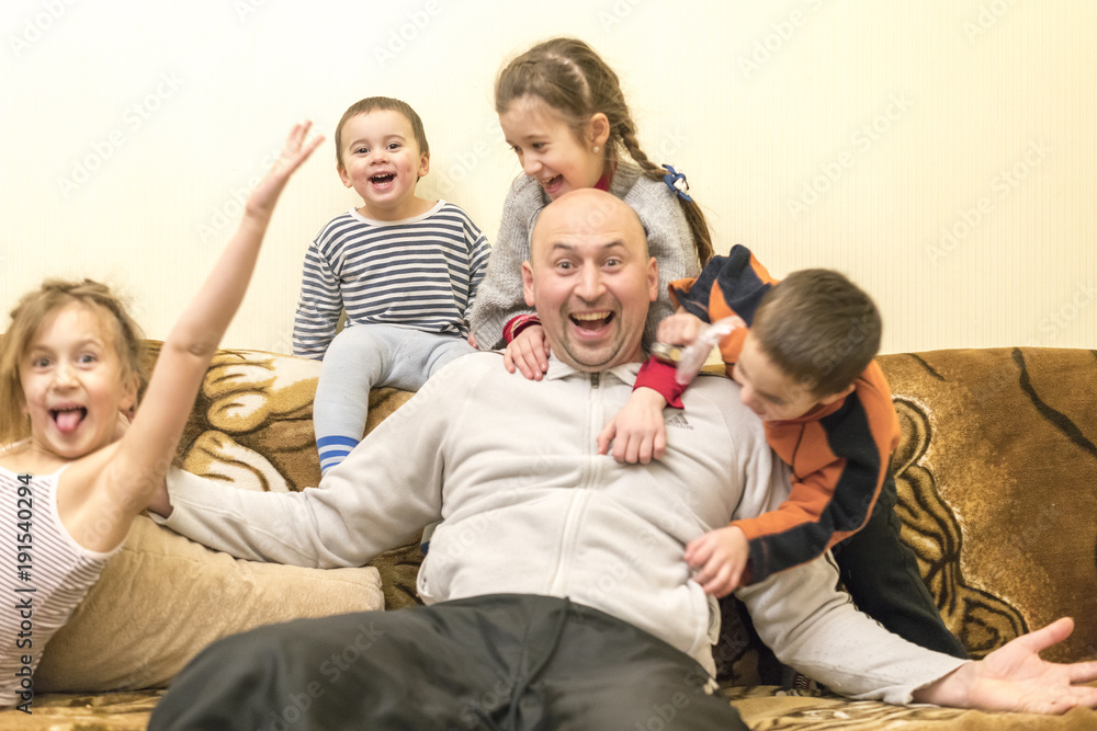 happy dad with four young children. Two girls and two boys. Selected focus