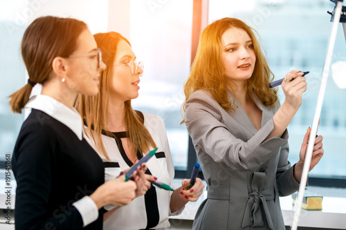 girls working in the office at the whiteboard