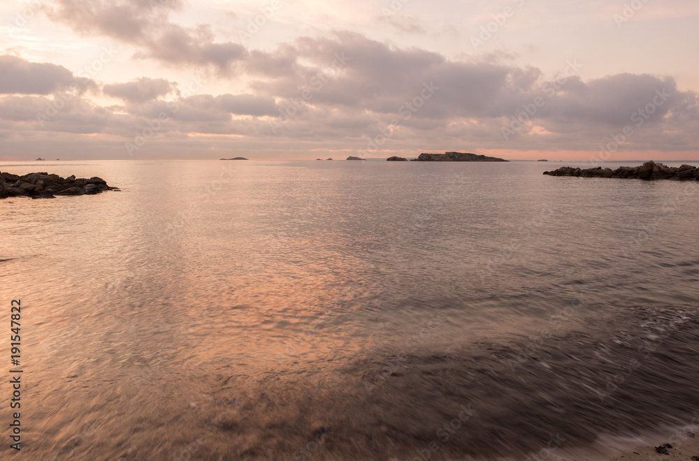 Fototapeta premium A violet sunrise on the beach of Ses figueretes, Ibiza