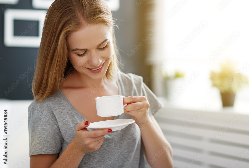 happy young woman with cup of morning coffee in bed happy young woman with cup of morning coffee in bed