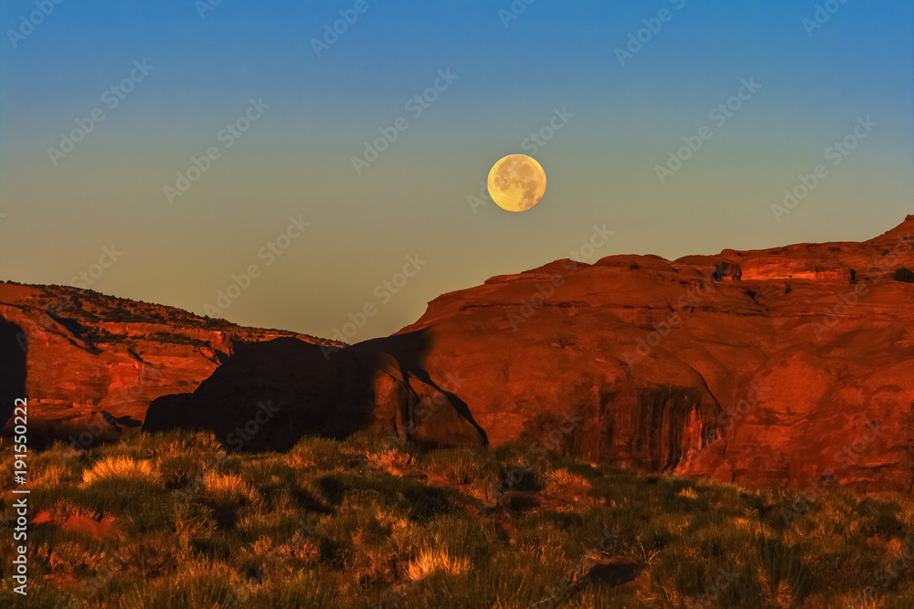 The moon setting down in early morning in Monument Valley Navajo Tribal Park, Arizona.