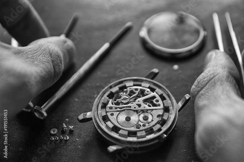 Watchmaker is repairing the mechanical watches in his workshop