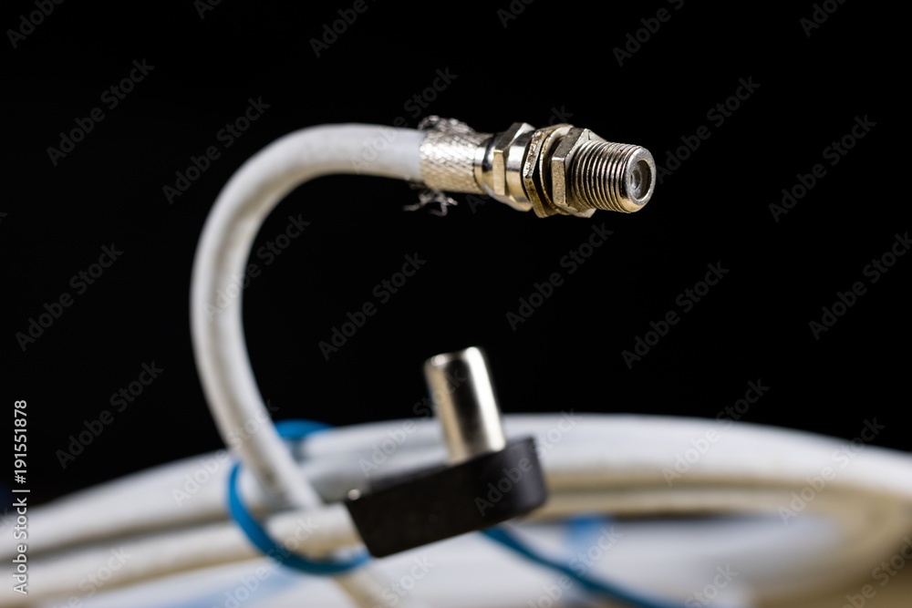 Electric cables, plugs and connectors on a wooden workshop table. Accessories and electrical components. Electric cables, plugs and connectors on a wooden workshop table. Accessories and electrical components.