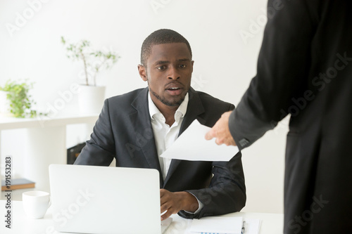 Εκτύπωση καμβά Surprised shocked african businessman getting unexpected dismissal notice from c