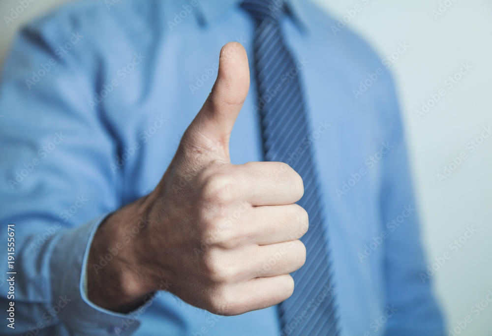 Businessman showing a thumbs up sign. Businessman showing a thumbs up sign.