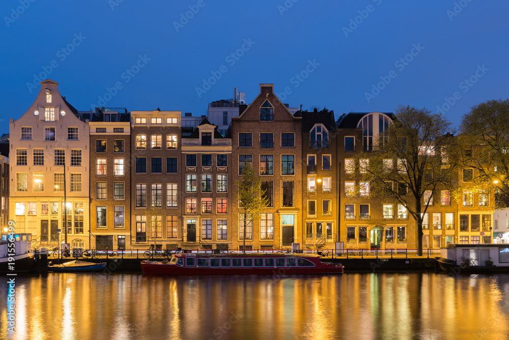 Canals and tradition house in Amsterdam at night. Amsterdam is the capital and most populous city of the Netherlands.