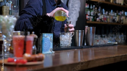 Expert barman is making cocktail at bar photo