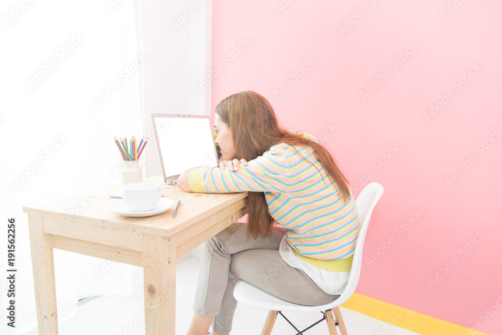 Happy relaxed young caucasian woman sitting in living room with a laptop , relax after a long work at laptop. Business, education and lifestyle concept Happy relaxed young caucasian woman sitting in living room with a laptop , relax after a long work at laptop. Business, education and lifestyle concept