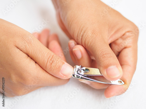 Closeup of a woman cutting nails  health care concept.