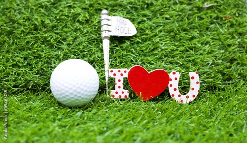 golf ball with I love you sign on green grass for valentine's day to golfer