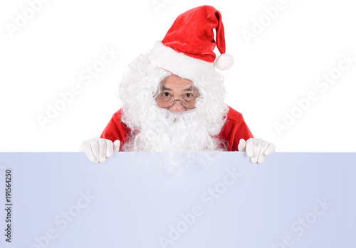 Santa Claus pointing in white blank sign with smile, isolated on white background ..copy space for Advertising christmas and happy new year festival © kittipong
