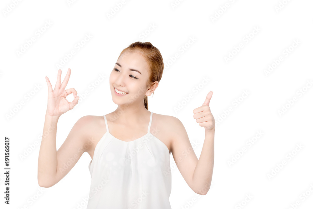 Natural Beauty Portrait. Beautiful smile Spa Woman . Perfect Fresh Skin.Portrait of the young asian beautiful girl make OK and good sign , isolated on white background Natural Beauty Portrait. Beautiful smile Spa Woman . Perfect Fresh Skin.Portrait of the young asian beautiful girl make OK and good sign , isolated on white background