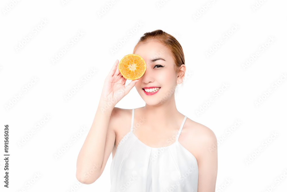 Natural Beauty Portrait. Beautiful smile Spa Woman . Perfect Fresh Skin.Portrait of the young asian beautiful girl with orange fruit in hand , isolated on white background Natural Beauty Portrait. Beautiful smile Spa Woman . Perfect Fresh Skin.Portrait of the young asian beautiful girl with orange fruit in hand , isolated on white background
