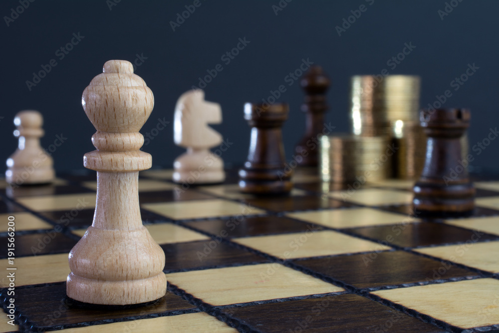 Chess & Money closeup, gold on a chess board, crisis intervention concept, selective focus Chess & Money closeup, gold on a chess board, crisis intervention concept, selective focus
