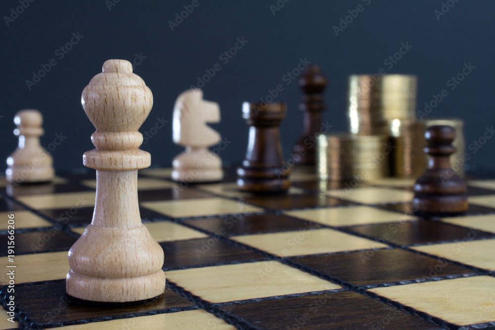 Chess & Money closeup, gold on a chess board, crisis intervention concept, selective focus Chess & Money closeup, gold on a chess board, crisis intervention concept, selective focus