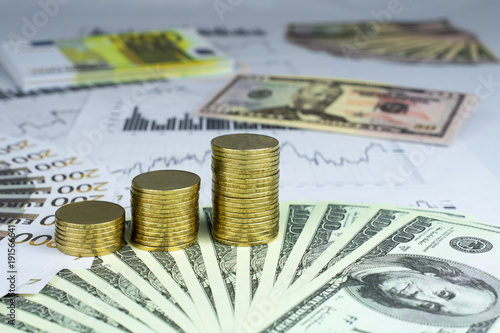 Personal saving, piles of gold coins on dollar bills,  supplementary pension concept closeup selective focus