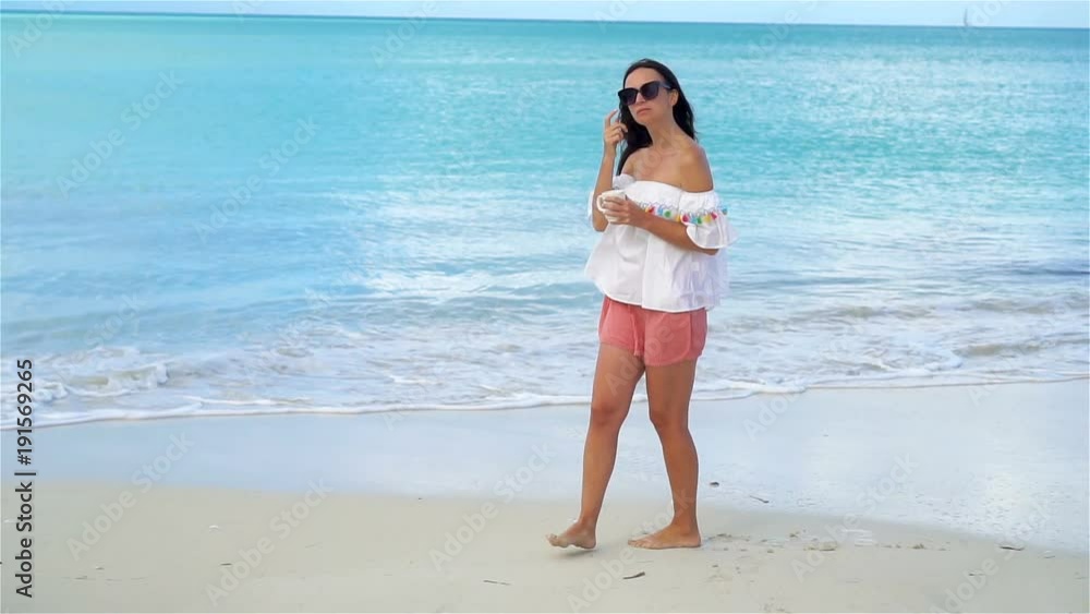 Young woman with cup of tea on the beach. Girl relax and enjoy holidays. SLOW MOTION Young woman with cup of tea on the beach. Girl relax and enjoy holidays. SLOW MOTION