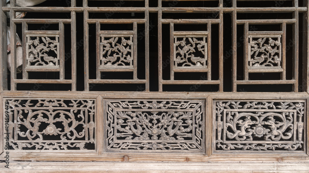Chinese Traditional wood carvings, disused wood windows covered with dust, beautiful wood carvings of Chinese traditional legend story.
