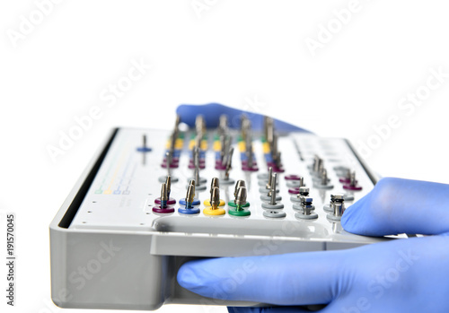 Dentist hands hold medical dental implant tool set 