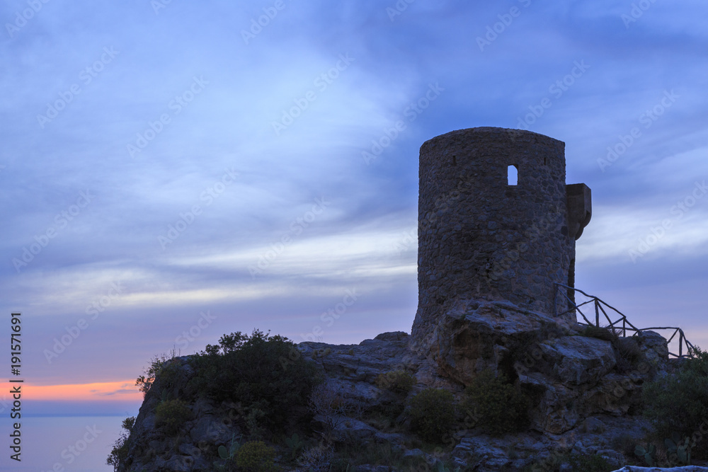 Europe, Spain, Balearic Islands, Mallorca. .Banyalbufar.Torre del Verger. 16th C. Watchtower over harbor. Sunset.