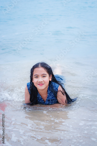 Little girl on the beach in summer day. © tachjang