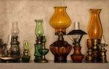 Collection of old-styled kerosene lamps on shelf
