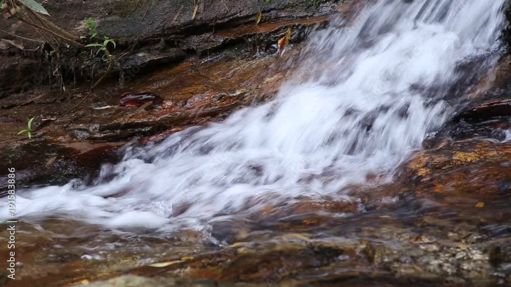 Natural waterfall and flowing pure fresh water with leaf and stone. waterfall in forest. Natural waterfall and flowing pure fresh water with leaf and stone. waterfall in forest.