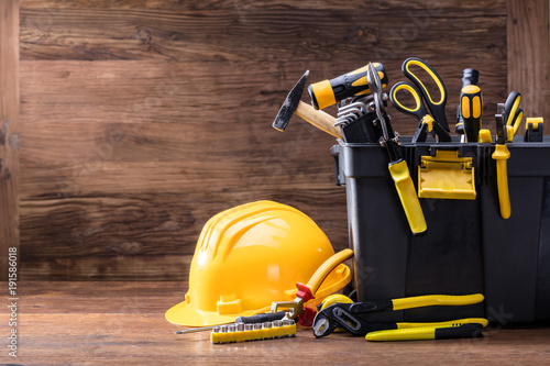 Safety Helmet With Tools In The Black Container photo