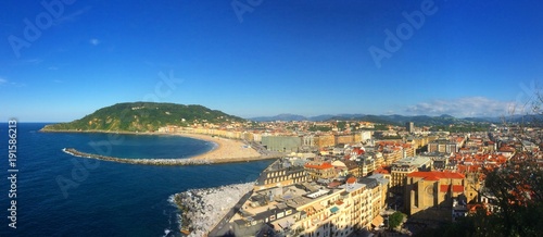 Panoramic view of San Sebastián Framed by golden beaches and lush hillsides. San Sebastián has undeniable allure, from its scenery to its grand architecture. This is San Sebastián, a petite city,Spain