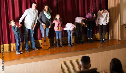 Performing group bowing to audience