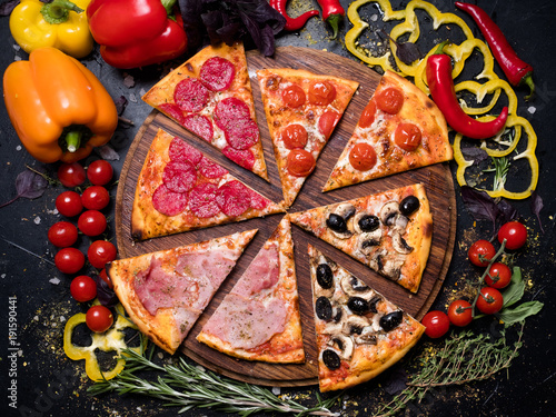 traditional italian food cuisine. delicious pizza slice quattro stagioni with ham prosciutto tomatoes olives and mushrooms photo