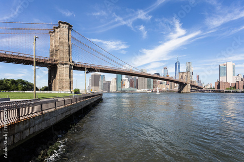 The famous Brooklyn bridge, from DUMBO, with the Manhattan financial district on the other side of the East river in New York city on a sunny day in the USA