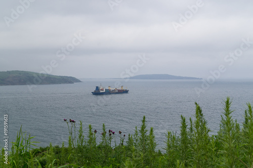 A merchant ship leaves its home port. photo