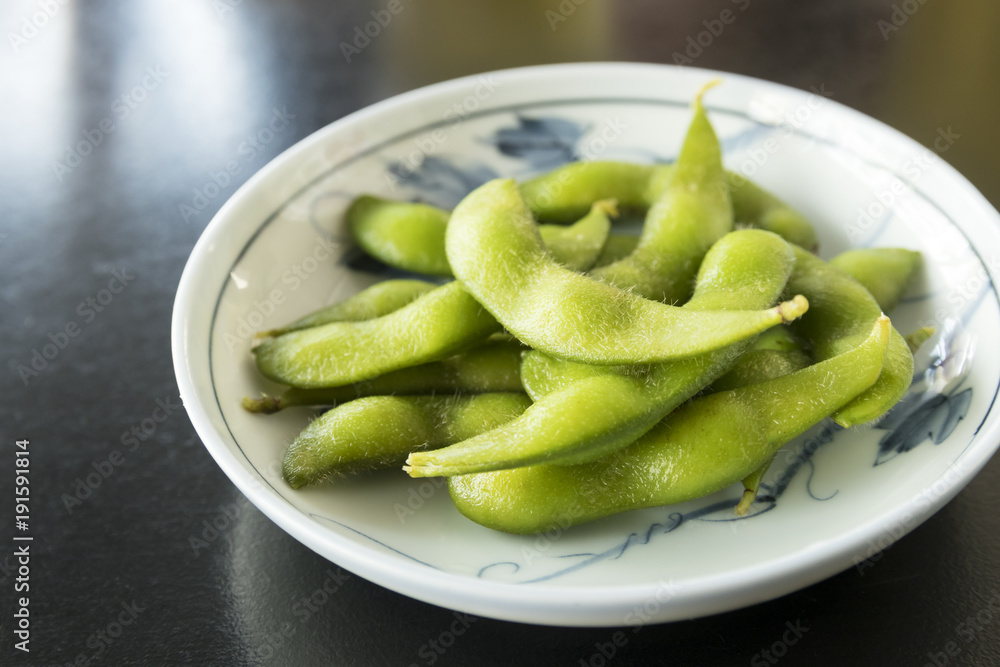 boiled green soy beans or edamame on plate boiled green soy beans or edamame on plate