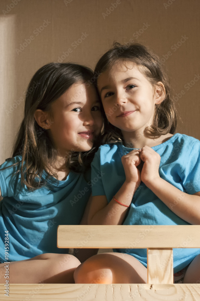 Little sisters whisper before going to bed in their beds Little sisters whisper before going to bed in their beds