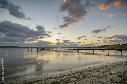 wooden pier  with old tires on it