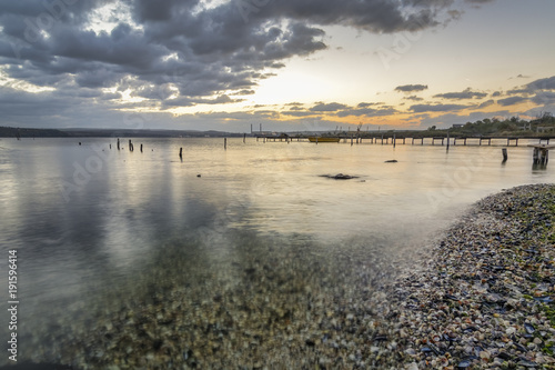 wooden pier  with old tires on it