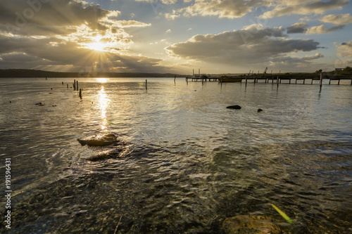 wooden pier  with old tires on it photo