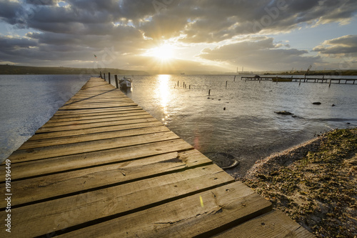 wooden pier  with old tires on it