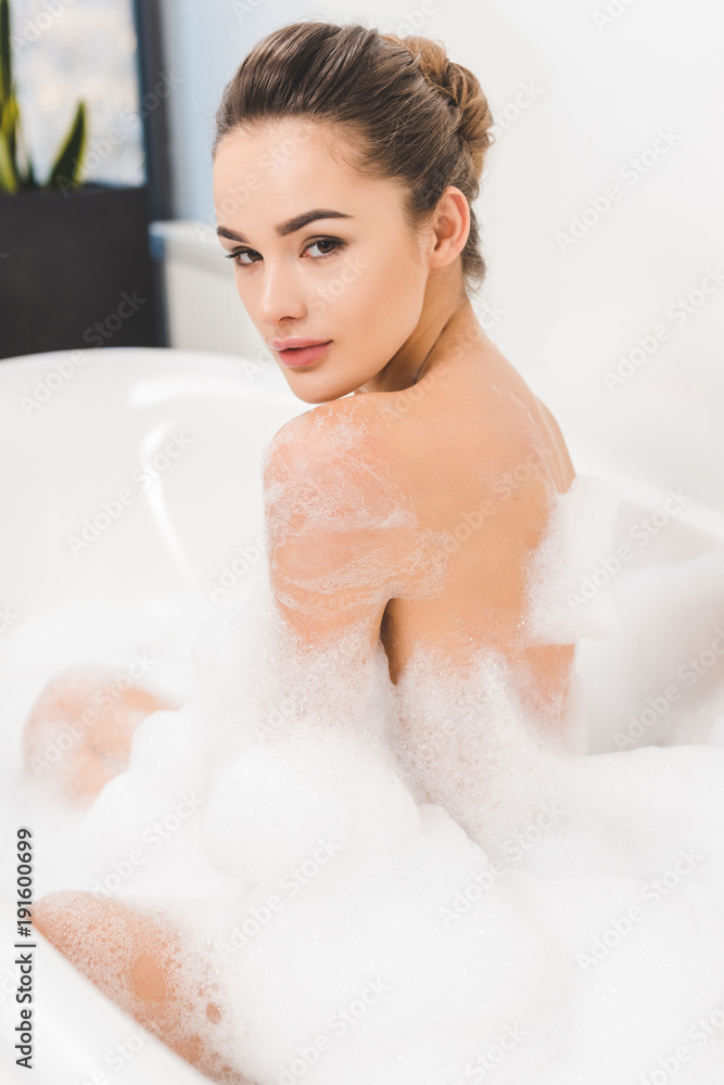 side view of beautiful young woman taking bath at home side view of beautiful young woman taking bath at home